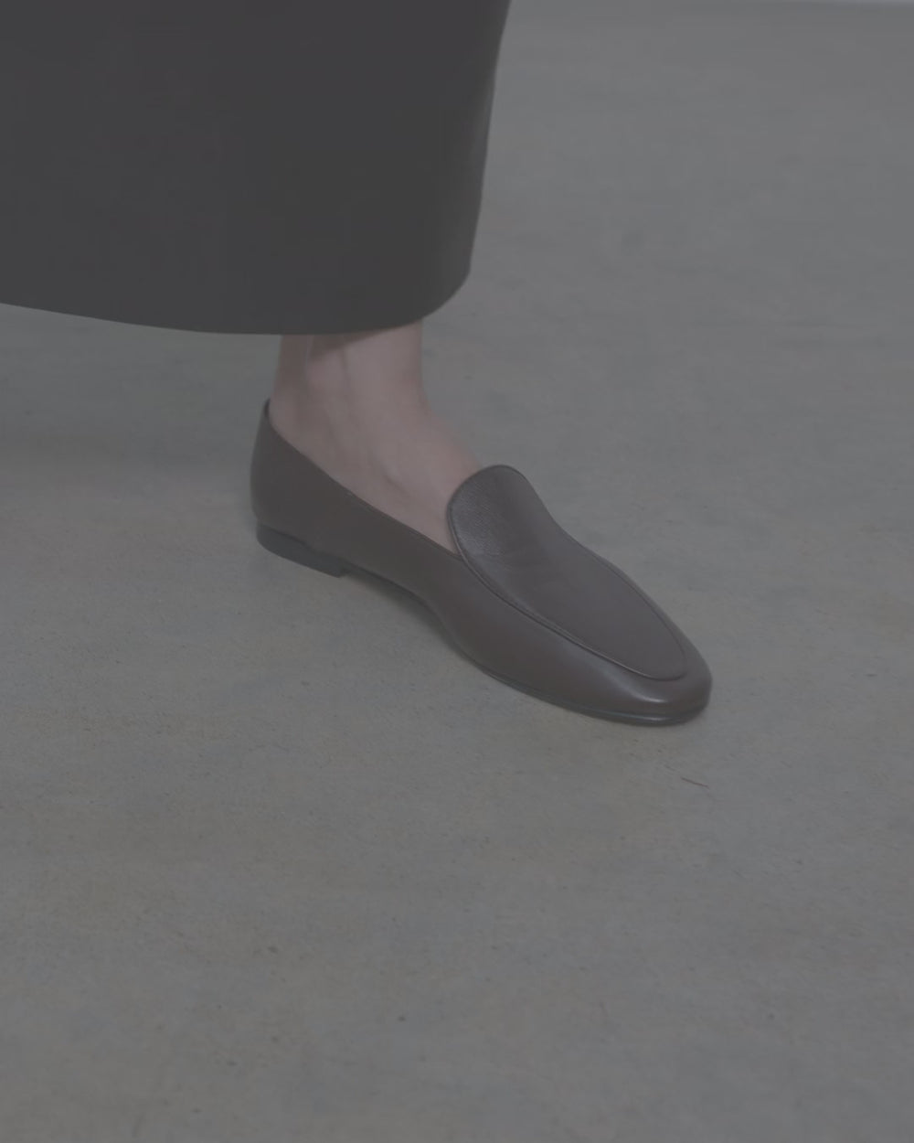 Model walking in Dear Frances Gio Loafers in espresso leather, showing the soft unlined upper and flat sole